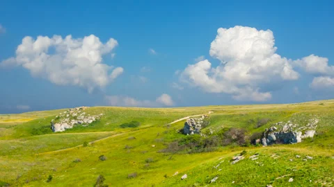 Green hills under a dense cloudy sky Stock-Footage 336744602