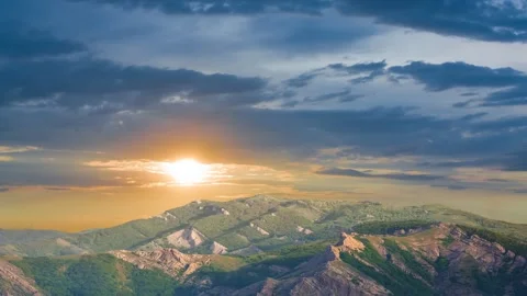 Green hills under dramatic evening sky Stock Footage 326832064