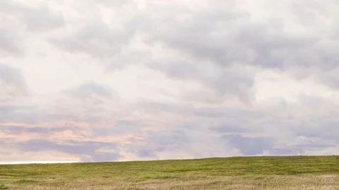 Green Hilltop With Clouds Rolling Over At Sunset Stock Footage 106157267