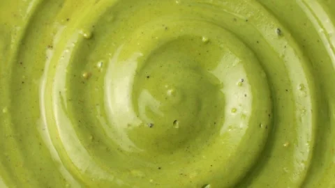 Green homemade pistachio paste texture circle rotation close up top view Stock Footage 295056419