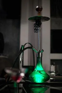 Green hookah standing on the table Stock Photos