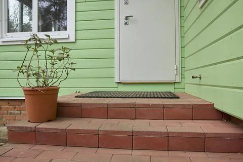 Green House Entry with Brick Steps and Potted Plant Stock Photos