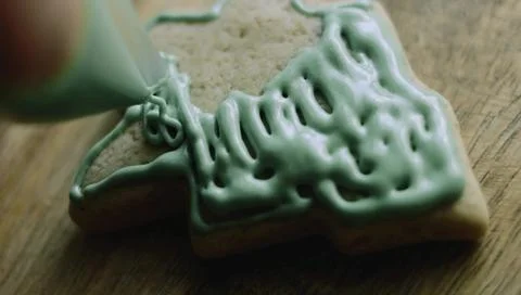 Green Icing Pattern Piped Across a Tree-shaped Cookie Stock Photos