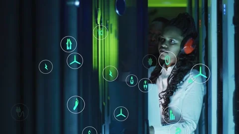 Green icons appearing at left edge drifting toward tech inspecting servers for Stock Footage 332936595