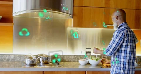 Green icons forming on backsplash responding to man seasoning salad, Stock Footage 329167417