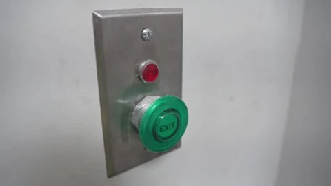 Green industrial push button with red indicator on metal panel Stock Footage 313850446