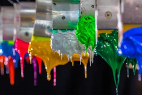 Green ink drop down from print handle. Stock Photos