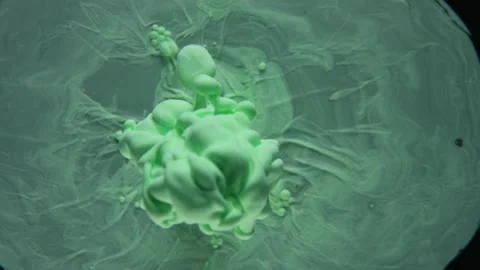 Green ink exploding in water shaping mystic shapes, clouds, figures underwater Stock Footage 148357492
