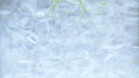 Green ink flowing through bubbly pattern liquid motion Stock Footage 127867735