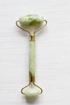 Green jade face roller Stock Photos