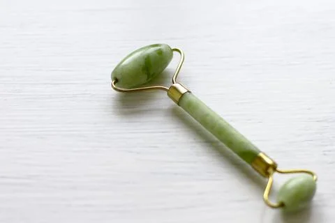 Green jade face roller Stock Photos