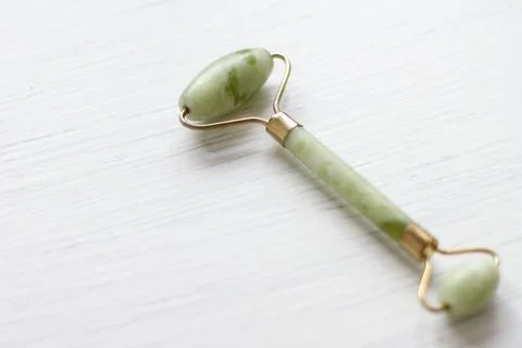 Green jade face roller Stock Photos