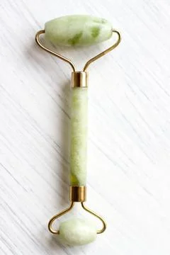 Green jade face roller Stock Photos