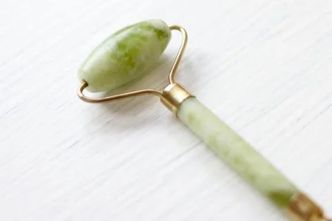 Green jade face roller Stock Photos