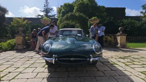 Green Jaguar E-Type convertible at Villa Bologna during Malta Classics Style Video stock 325366244