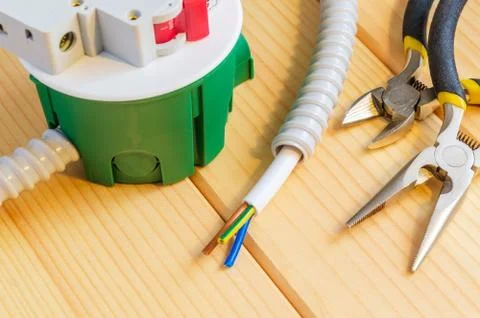 Green junction box with wire and tools for repairing electrics in the house Stock Photos