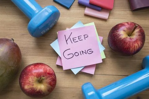 Green Keep Going Sticky Note Surrounded by Fresh Fruit and Fitness Accessorie Stock Photos