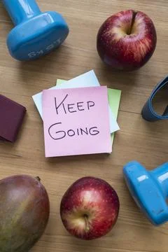 Green Keep Going Sticky Note Surrounded by Fresh Fruit and Fitness Accessorie Stock Photos