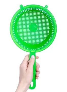 Green kitchen sieve colander in hand Stock Photos