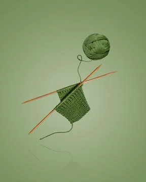 Green knitted wool and knitting needles Stock Photos