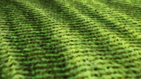 Green knitted wool, pullover fabric is waving background. Close up, macro sho Stock Footage 147223250