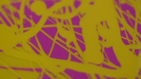 Green lacquer drips onto a mixture of yellow and pink nail polish. Stock Footage 77553096