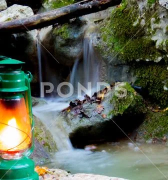 Green lantern lit with stream behind Stock Photos