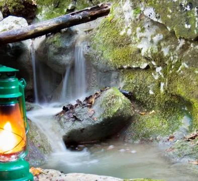 Green lantern lit with stream behind Stock Photos