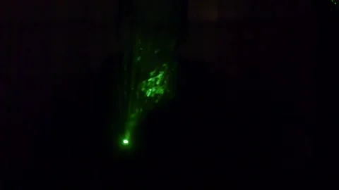 Green laser Light  through smoke Stock Footage 135833426