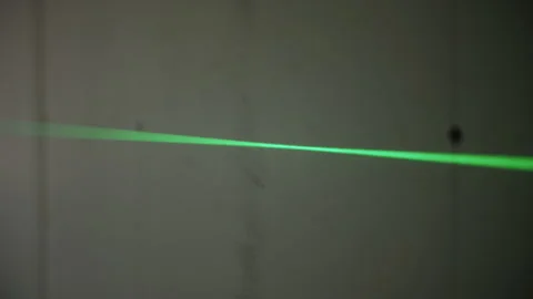 Green laser line projected on wall during construction Stock Footage 314058526