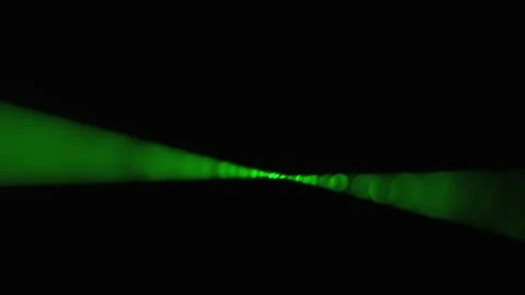 Green Laser Ray on a Black Background. Power laser beam shining in Fog Stock Footage 141177671