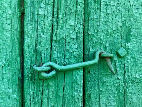 Green latch hook on an old green painted wooden gate Stock Photos