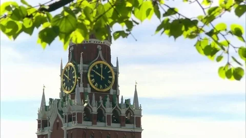 Green Leafs against Kremlin Clock Tower at background. Spasskaya Tower, Moscow Stock Footage 92538864