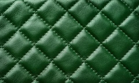 Green leather texture background with diagonal stitching. Close up seamless g 스톡 사진