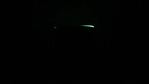 Green led light of smart speaker assistent in a dark background Stock Footage 166734553