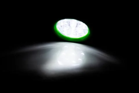 Green LED torch shining on a surface Foto stock