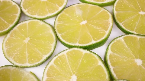 Green lemon lime fruit slices looping texture pattern closeup video Stock Footage 99012784