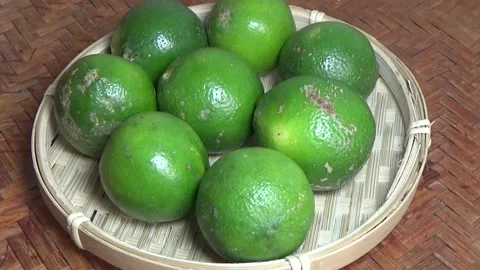 Green lemon on the plate Video stock 328492850