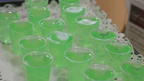Green lemonade in plastic glasses. Close up isometric view. Stock Footage 304316923