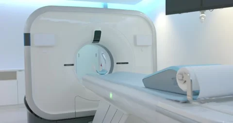 Green light is activating as table is sliding into CT gantry for scan alignment Stock Footage 334841986