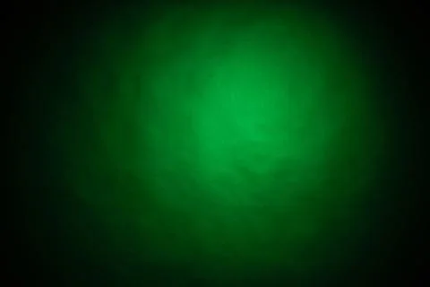 Green light on black background Stock Photos