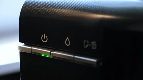 The green light on the printer is flashing, indicating of the device or ready to Stock Footage 313375098