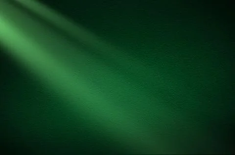 Green light rays on dark green background. Abstract green light background. Stock Photos