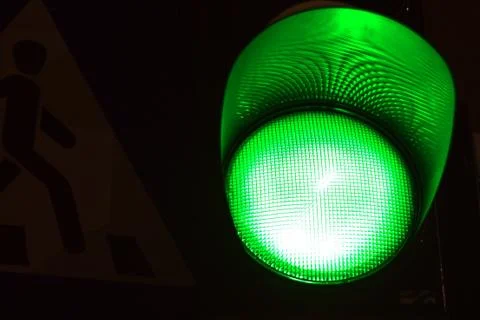 Green light of traffic light on the crossing. Road crossing permit, signal to Stock Photos