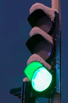 Green light traffic light on a dark background. A closeup photo of green traf Stock Photos