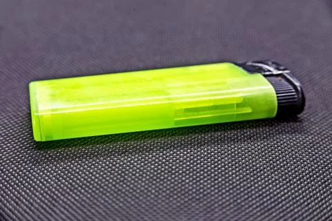 Green lighter on black background Stock Photos