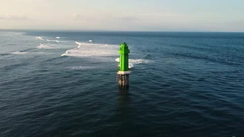 Green lighthouse in the ocean on sunset Stock Footage 156295878