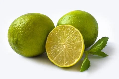 Green lime on a light background. lime cut in half. sprig of mint Stock Photos