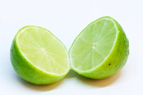 A green lime split in half on white background Stock Photos