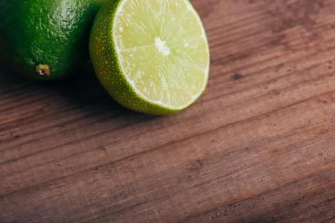 Green lime on wooden rustic table Stock Photos